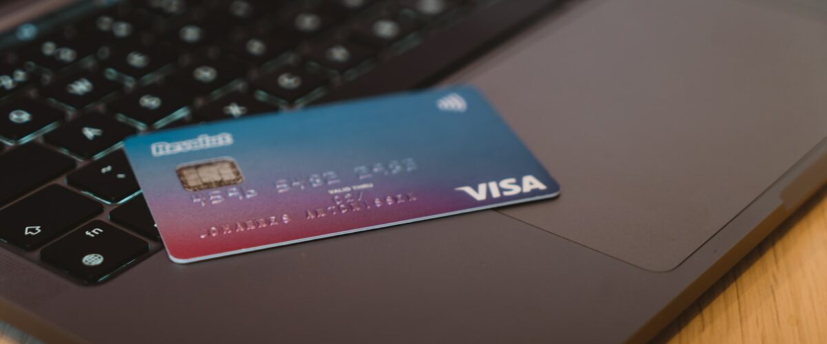blue and white visa card on silver laptop computer